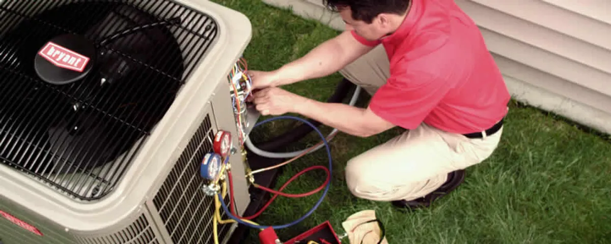 HVAC technician servicing an outdoor air conditioner unit in Duluth, MN